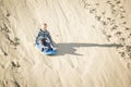 Thrill seeking boy Playing in the Sand Dunes Outdoor Lifestyle