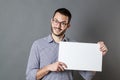 Thrilled young businessman holding banner for copy space text