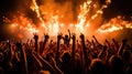 thrilling concert scene with pyrotechnics lighting up the stage as an ecstatic audience raises their hands in unison Royalty Free Stock Photo