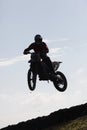 Thrilling rally bike race captures mid-air jump. Royalty Free Stock Photo