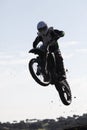 Thrilling rally bike race captures mid-air jump. Royalty Free Stock Photo