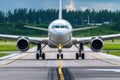 Thrilling Takeoff: A Front View of a Commercial Airplane on the Runway Royalty Free Stock Photo