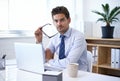 He thrives in this job. A handsome businessman working on a laptop in his office. Royalty Free Stock Photo