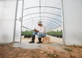 A thriving farm requires tons of planning. a young man writing notes while working in a greenhouse on a farm. Royalty Free Stock Photo