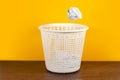 Throw it in the waste paper basket or bin concept for business frustration, stress and writers block Royalty Free Stock Photo