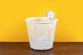 Throw it in the waste paper basket or bin concept for business frustration, stress and writers block Royalty Free Stock Photo