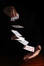 throwing cards from one hand to the other against a black background with copy space, business metaphor or concept for new