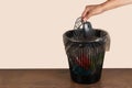 throwing a computer mouse in the trash bin, a computer mouse in hand in front of the trash bin, recycling plastic Royalty Free Stock Photo