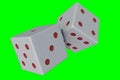 Throwing dices on a green screen background Royalty Free Stock Photo