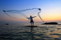 Throwing fishing net during sunrise Royalty Free Stock Photo