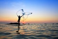 Throwing fishing net during sunrise Royalty Free Stock Photo