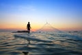 Throwing fishing net during sunrise Royalty Free Stock Photo