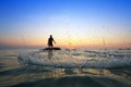 Throwing fishing net during sunrise Royalty Free Stock Photo