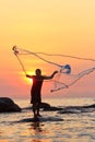 Throwing fishing net during sunrise Royalty Free Stock Photo