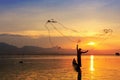 Throwing fishing net during sunset Royalty Free Stock Photo