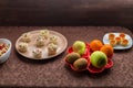 Throwing forks on the table set with salad in tartlets, fruit snacks.