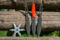 Throwing knife and Shuriken throwing star, on wooden backgroun