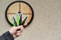 Throwing knives. Sport and hobby . Throwing knives in a man& x27;s hand close-up and a target on the wall.Outdoor sports
