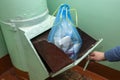 Throwing out garbage Packed in a garbage bag using a home trash chute in Russia Royalty Free Stock Photo