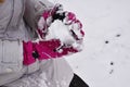 Girl sculpts a snowball. The first snow for games