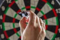 Throwing syringe in the form of a dart with the inscription vaccine hand into a dartboard. Coronavirus vaccine concept