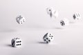 Thrown dice bouncing across a white surface Royalty Free Stock Photo