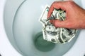 Throws money bills in the toilet Royalty Free Stock Photo