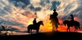 Thrre cowboys silhouette at sunset Royalty Free Stock Photo