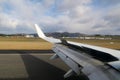 Thrust reversal at Hobart Airport with rainbow in the background.