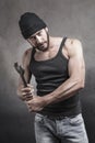 Thug preparing to use a wrench as a weapon Royalty Free Stock Photo