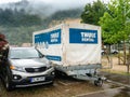 Thule rental cargo trail tug in parking lot next to Kia SUV Royalty Free Stock Photo