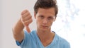 Thumb Down by Young Man, Indoor Portrait Royalty Free Stock Photo