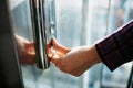 The thumb presses the Elevator button, a hand reaching for the button, the girl waiting for Elevator, push button start