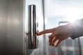 The thumb presses the Elevator button, a hand reaching for the button, the girl waiting for Elevator, push button start Royalty Free Stock Photo