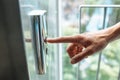 The thumb presses the Elevator button, a hand reaching for the button, the girl waiting for Elevator, push button start