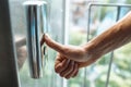 The thumb presses the Elevator button, a hand reaching for the button, the girl waiting for Elevator, push button start Royalty Free Stock Photo