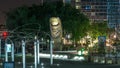 Thumb sculpture by Cesar Baldaccini night timelapse and tower block in business district Defense