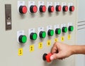 Thumb touch on red emergency stop switch and green start button Royalty Free Stock Photo