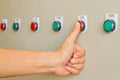 Thumb touch on red stop switch on control panel. Royalty Free Stock Photo