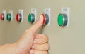 Thumb touch on red stop switch on control panel. Royalty Free Stock Photo