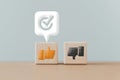 Thumb up ,down icon on wooden cube block with approval sign on white speech bubble , like or dislike , approve or reject,