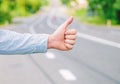 Thumb up gesture try stop car road background. Hand gesture hitchhiking. Make sure you know right gestures to stop car