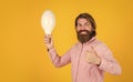 thumb up for success. Business idea and creativity symbol. bearded thinking man hold bulb. Energy saving. innovative Royalty Free Stock Photo