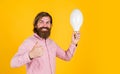 thumb up for success. Business idea and creativity symbol. bearded thinking man hold bulb. Energy saving. innovative Royalty Free Stock Photo