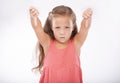 Thumbs down, girl or portrait of kid in studio for bad news, unhappy emoji sign and vote no on white background Royalty Free Stock Photo