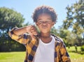 Thumbs down, portrait or angry child in park unhappy, upset or frustrated in nature. Young African boy kid being Royalty Free Stock Photo
