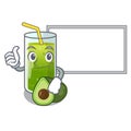 Thumbs up with board avocado smoothies in a mascot glass Royalty Free Stock Photo