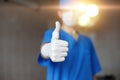 Thumbs up. Doctor in mask and blue costume approves Royalty Free Stock Photo