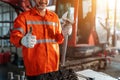 Thumbs up of excavator repair technician with large iron wrench in a hand, Powerful Professional Mechanic. Heavy Duty Equipment