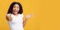 Thumbs-up gesture. Overjoyed african american lady showing like sign, yellow background, panorama with free space Royalty Free Stock Photo